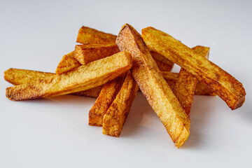 golden french fries on a white acrylic background