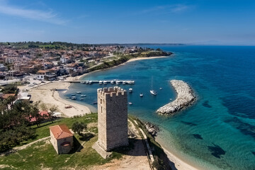 Aerial view of  byzantine tower and beach of village Nea Fokea in Chalkidiki Greece - obrazy, fototapety, plakaty