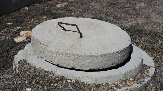 manhole cover, concrete manhole cover, well and cover in the garden,
