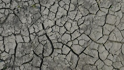 Lifeless desert land dry lake bed with cracked ground. Drought and crisis environment. Global warming. Lifeless, waterless soil due lack of moisture. Mud crack as result of reduction in water content