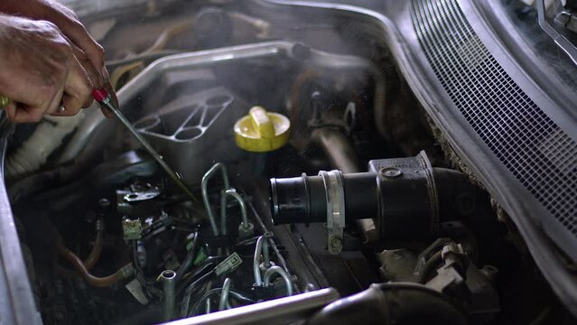 Auto Mechanic Repairs Faulty Vehicle Fuel System With Air Gun in Repair Shop Footage.