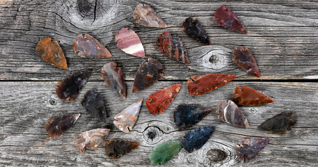 Native American arrowheads on rustic wood surface for a vintage concept