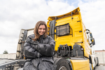 Caucasian young woman driving truck. trucker female worker, transport industry occupation 