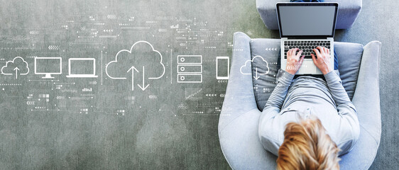 Cloud computing with man using a laptop in a modern gray chair