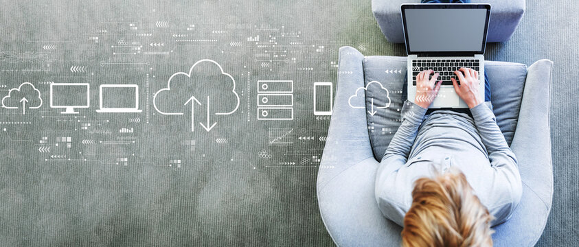 Cloud computing with man using a laptop in a modern gray chair