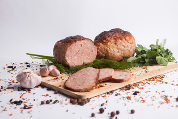 chopped roast pork on a wooden board, with rosemary and tomatoes, isolate