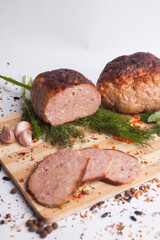 chopped roast pork on a wooden board, with rosemary and tomatoes, isolate