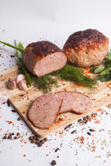 chopped roast pork on a wooden board, with rosemary and tomatoes, isolate