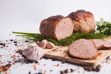chopped roast pork on a wooden board, with rosemary and tomatoes, isolate