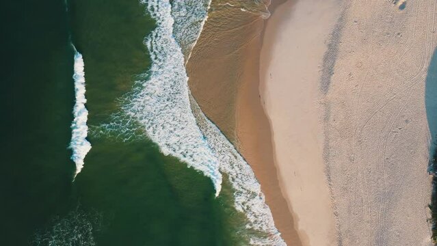 Aerial view of Reserva beach, Marapendi lagoon and car traffic on Lucio Costa avenue. Barra da Tijuca and Recreio, in Rio de Janeiro, Brazil. Sunrise. Sunny day. Drone take. Praia da Reserva.