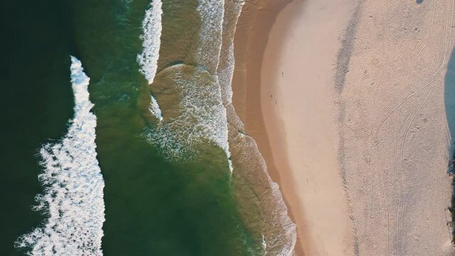 Aerial view of Reserva beach, Marapendi lagoon and car traffic on Lucio Costa avenue. Barra da Tijuca and Recreio, in Rio de Janeiro, Brazil. Sunrise. Sunny day. Drone take. Praia da Reserva.