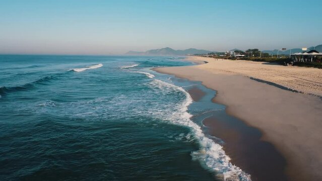 Aerial view of Reserva beach, Marapendi lagoon and car traffic on Lucio Costa avenue. Barra da Tijuca and Recreio, in Rio de Janeiro, Brazil. Sunrise. Sunny day. Drone take. Praia da Reserva.