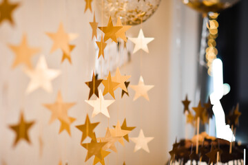 A photo zone decorated with golden stars for a birthday celebration.
