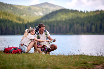 Couple  looking at a travel map.adventure on mountain
