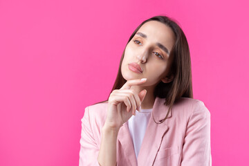 Portrait of beautiful young woman in pink jacket thinking isolated on red background