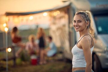 Girl in front of camper van.Travel and friendship celebration concept