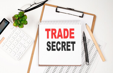 Office desk table with paper sheet, notepad ,chart and calculator. Top view TRADE SECRET