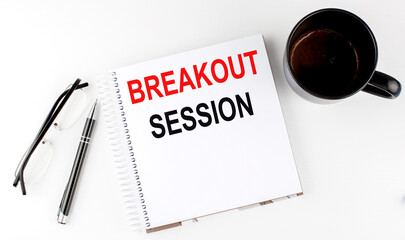 Coffee,glasses,pen and notebook written with Breakout Sessions on white background.