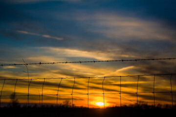 Sunset behind the fence