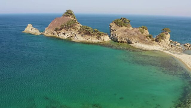 Rocky promontory with a strait between the rocks. Untouched nature. Drone view