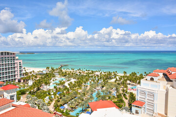 Ocean and beach view from balcony overlooking a resort pool in Nassau, Bahamas