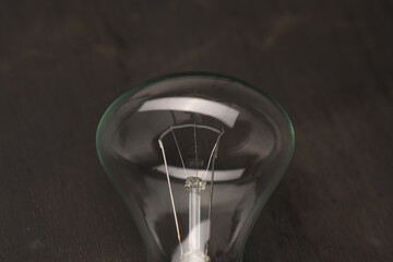 Fototapeta na wymiar tungsten light bulb lit on black background
