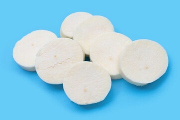 Cassava slices on blue background.