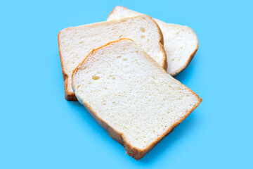 Sliced of bread on blue background.