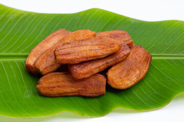 Sun dried bananas on leaf on white background.