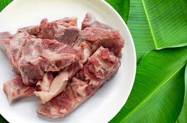 Raw pork bone isolated on white plate