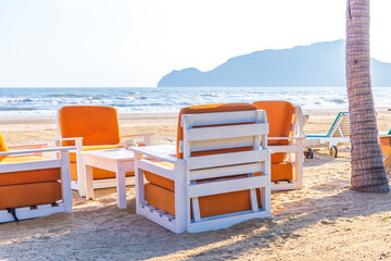 Sofa bench or seat and sofa on the sand beach of sea.