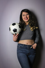 woman posing with soccer ball making facial expressions