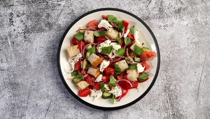 Fotobehang Tuscan Panzanella, traditional Italian salad with tomatoes and bread. Vegetarian panzanella salad on a round plate on a dark gray background. Top view, flat lay © SergeyST78
