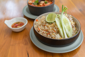 Fried rice with pork on wooden table