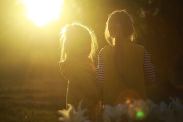 Children walk in the summer in nature. Child on a sunny spring morning in the park. Traveling with children.