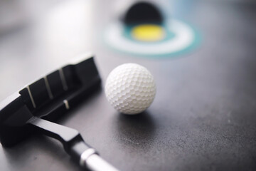 Sport and healthy lifestyle. Mini golf. White golf ball and set for minigolf on the table. Sports background with golf concept.