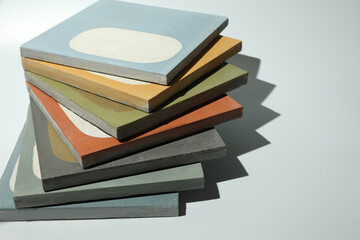 Demonstration fan layout of concrete tiles of different colors and textures. Unusual minimalistic design of paving slabs is presented by a modern architect at the exhibition stand