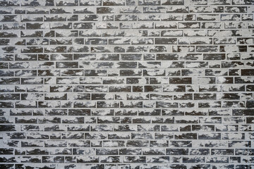 Background from a grey brick wall with a lot of cement on the surface