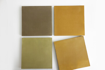 Fototapeta premium Layout of concrete tiles of square shape of autumn shades on the exhibition stand of the hardware store. Advertising of building materials for the creation of modern landscape designs