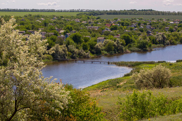 Summer rural landscape with a bridge over the river
