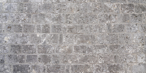old gray cement background with old brick bricks