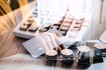 Credit bank card, money and coins on the home wood table, with selective focus, soft light and vintage filter, business concept