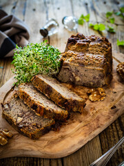 Tasty pate with walnuts on cutting board