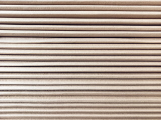 Obraz premium Side view of a corrugated cardboard. Cardboard boxes are folded on a pallet. Corrugated cardboard sheets are one by one.