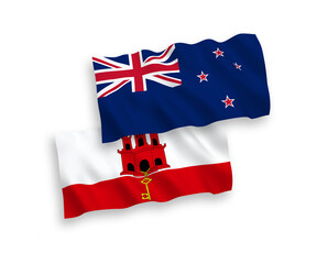 Fototapeta premium National vector fabric wave flags of New Zealand and Gibraltar isolated on white background. 1 to 2 proportion.