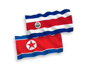 National vector fabric wave flags of North Korea and Republic of Costa Rica isolated on white background. 1 to 2 proportion.