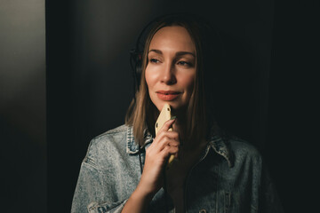 Obraz premium Beautiful young girl with purple pink hair listening to music on headphones, street style, outdoor portrait, hipster girl, music, mp3, Bali, beauty woman, sunglasses, orange color, concept