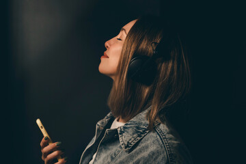 Beautiful young girl with purple pink hair listening to music on headphones, street style, outdoor portrait, hipster girl, music, mp3, Bali, beauty woman, sunglasses, orange color, concept