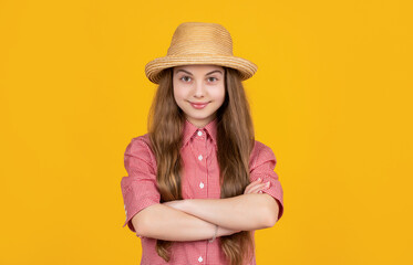 smiling teen kid in straw hat on yellow background