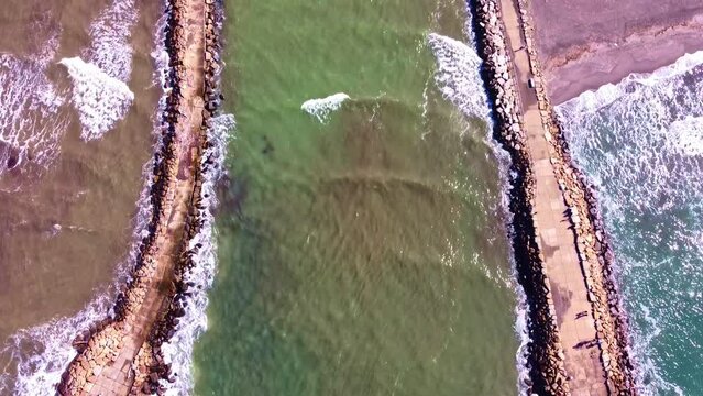 Aerial view of the pier at the mouth of Fiora river in Montalto di Castro, Lazio
